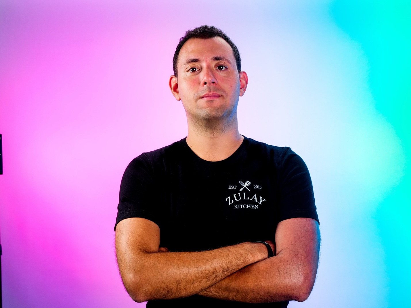 A person with his arms crossed
Description automatically generated